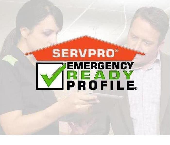 A man and a woman looking at a cell phone- says SERVPRO Emergency Ready Profile